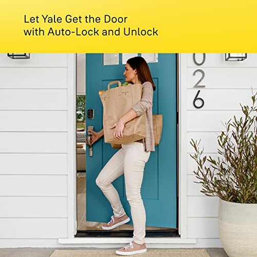 Woman entering home with groceries, showcasing auto-lock feature on door