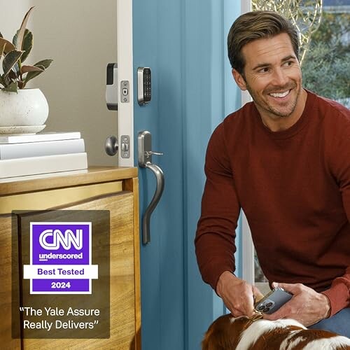 Man with dog using Yale smart lock, awarded CNN Best Tested 2024